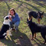 Woman outdoors with 3 dogs